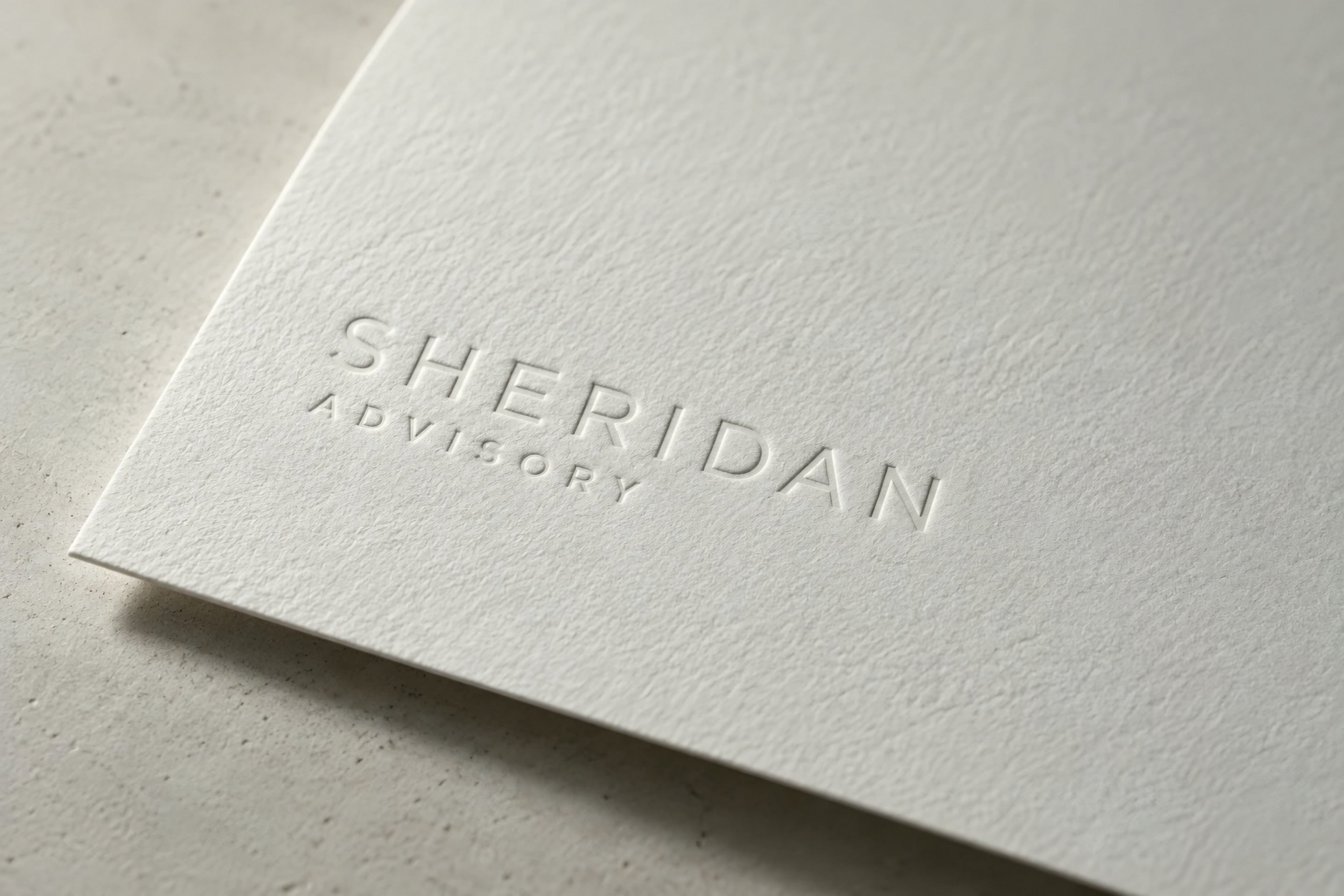 Sheridan Advisory blind-embossed on textured white paper