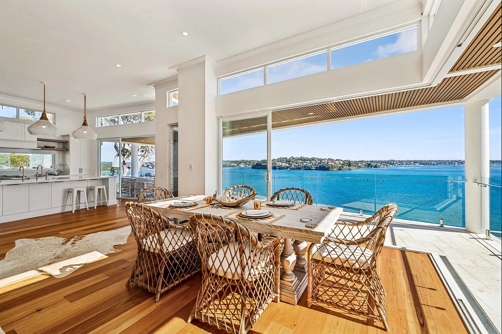 Dining room with rattan chairs and water views