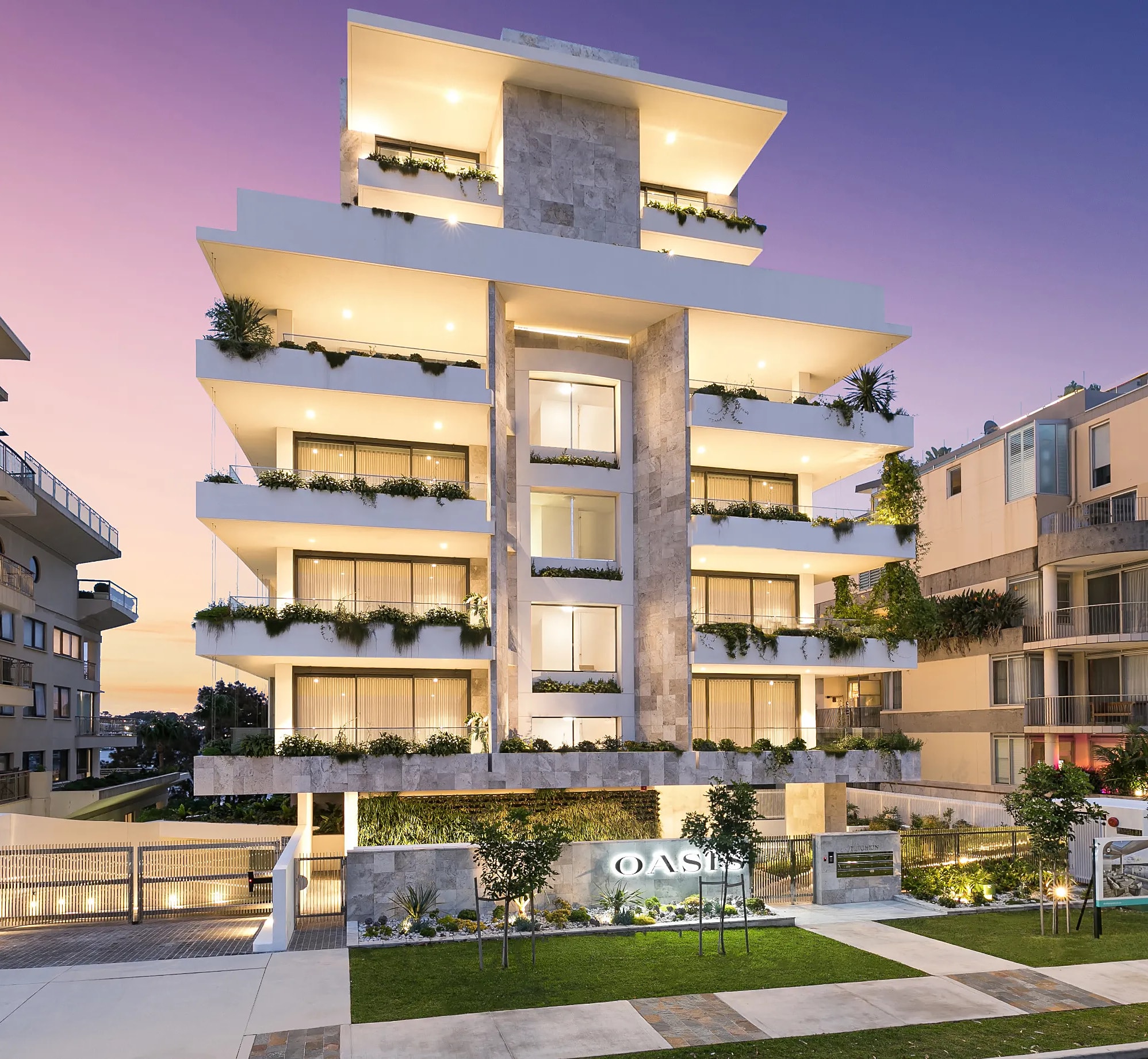An apartment building lit at dusk