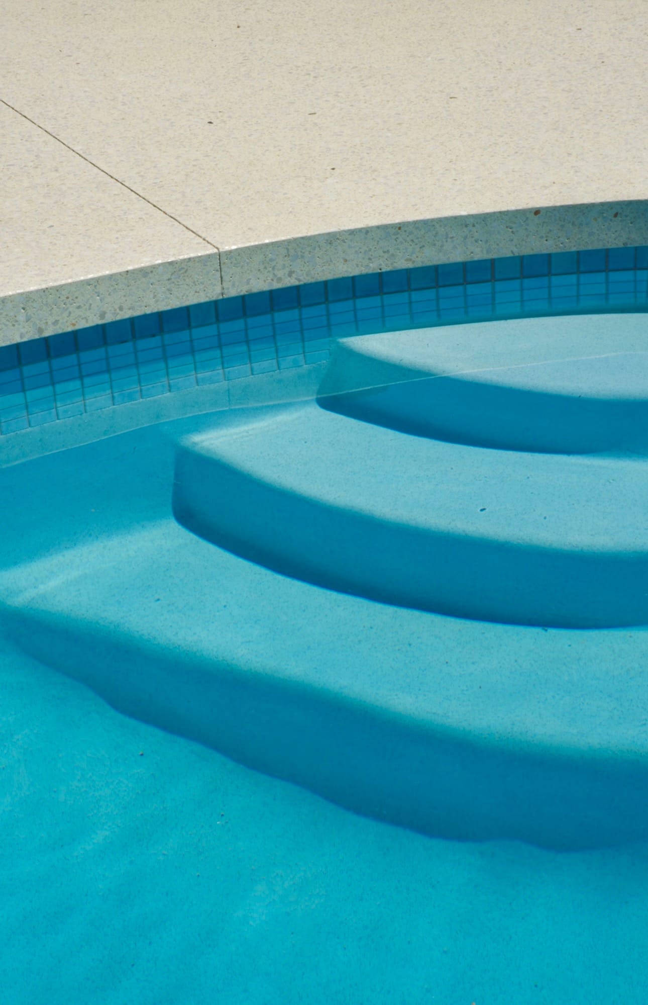 Wide entry steps into a blue pool