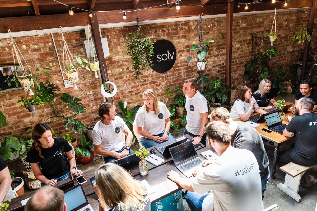 A team working in a leafy courtyard