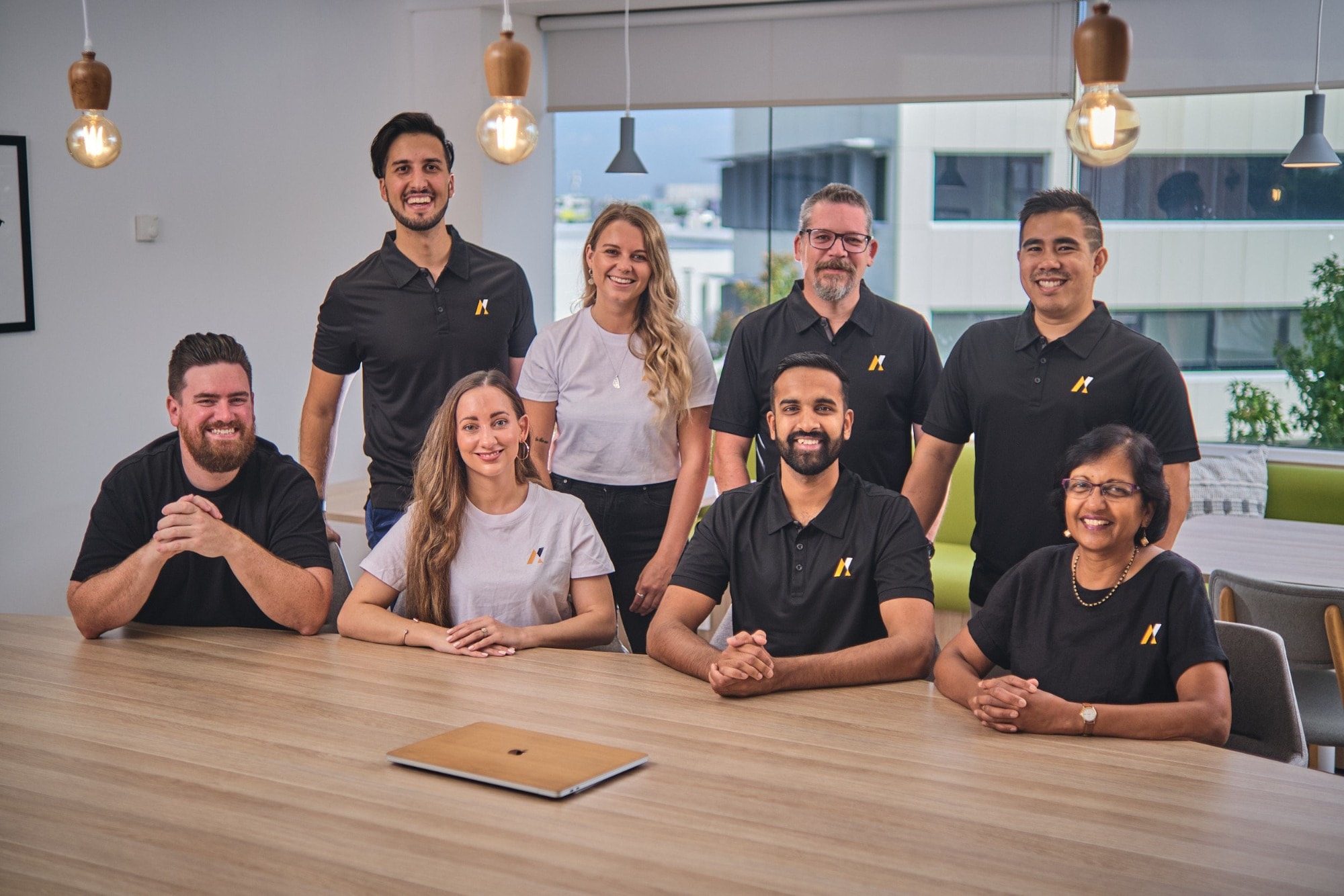 A team gathered around a timber table