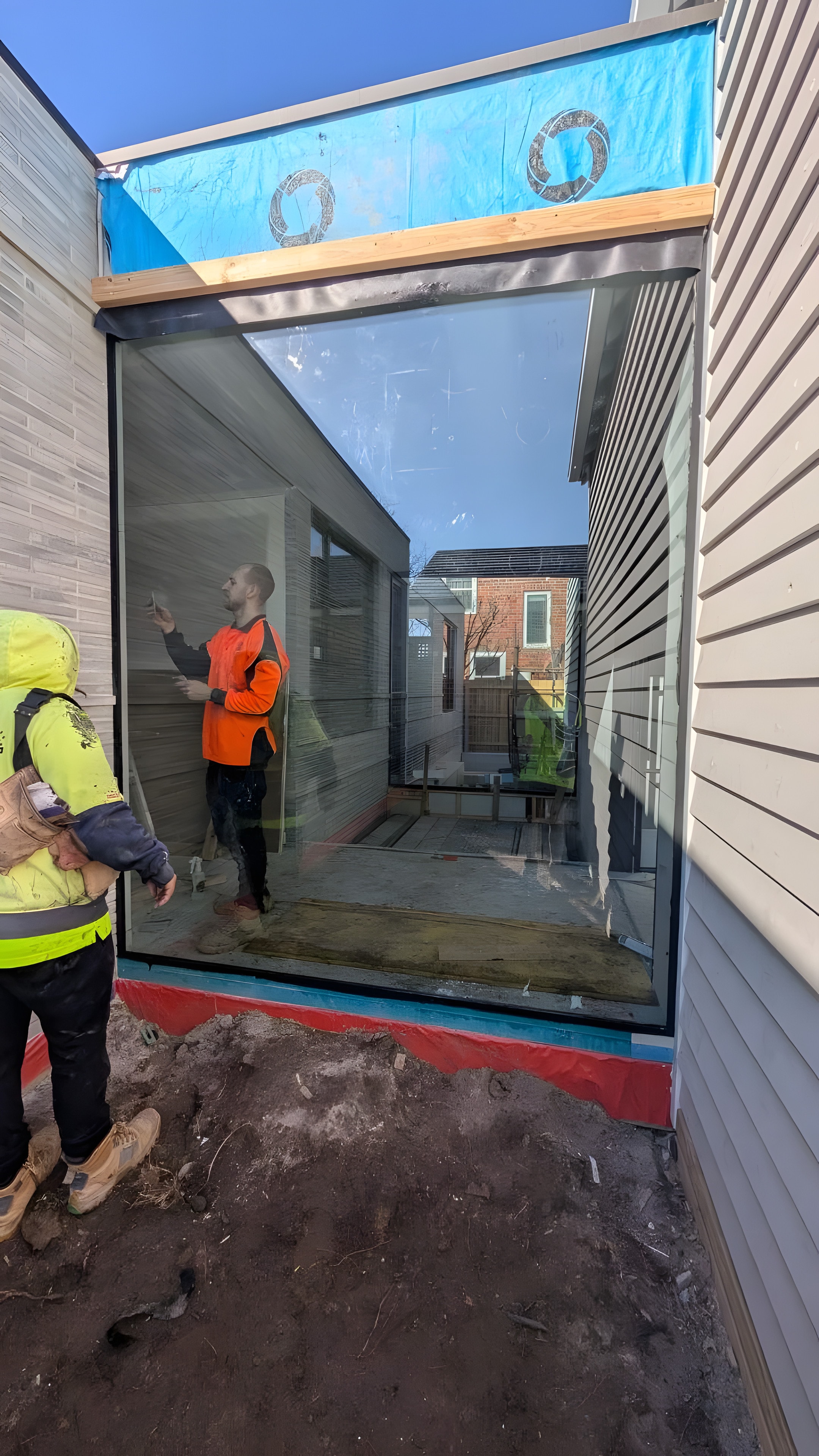 A glazier checking a large fixed pane on site