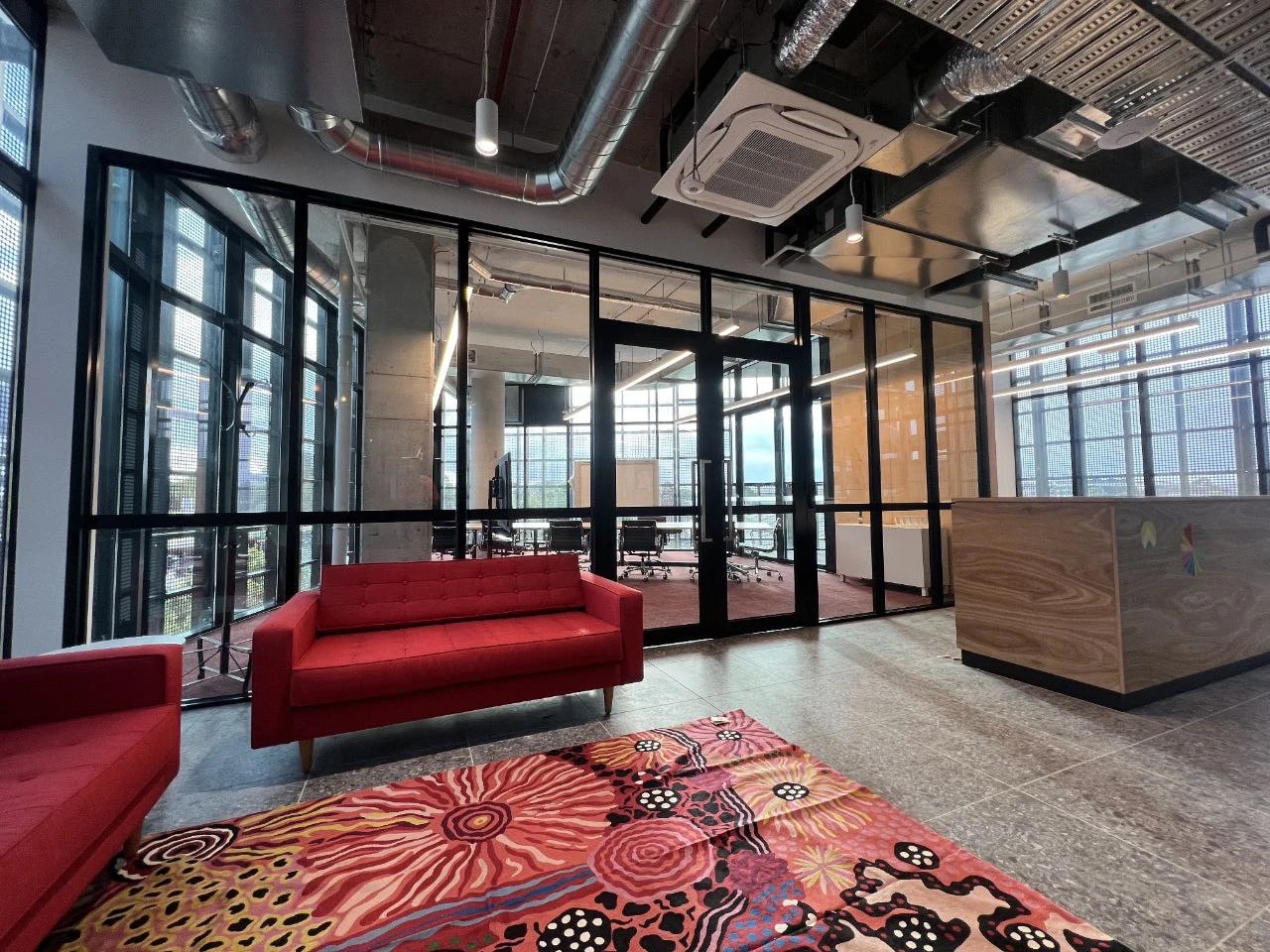 Black-framed glass partitions around a boardroom